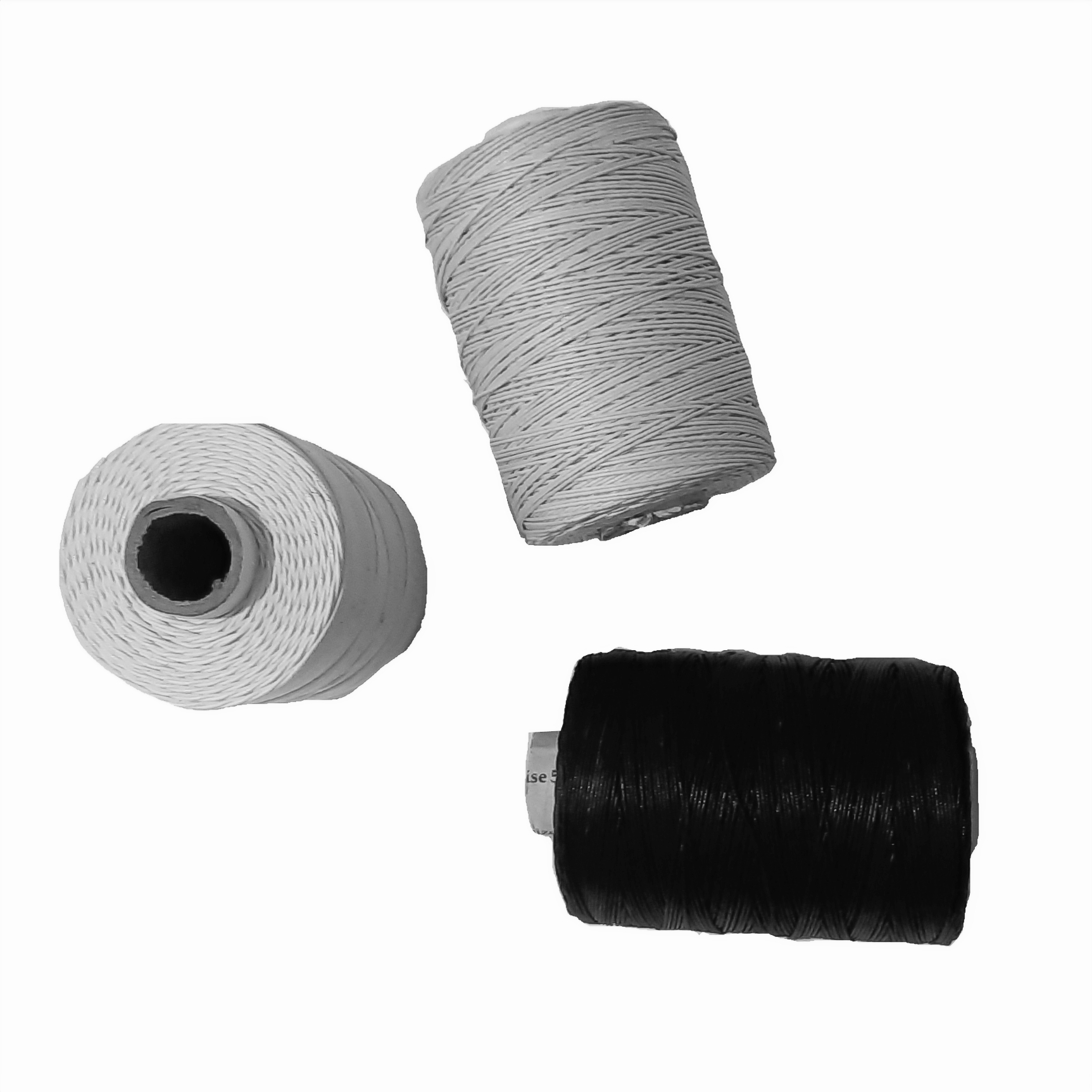 The Zone International's white and black glazed cotton stitching thread spools